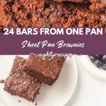 Sheet pan brownies stacked and served on plates with berries