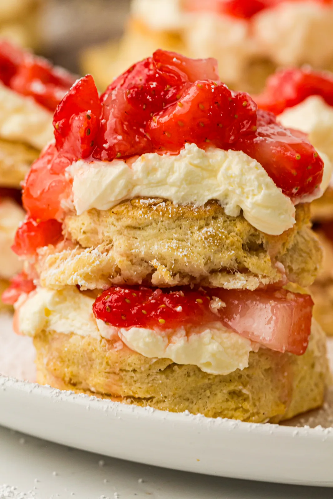 Strawberry shortcake stacked with berries and whipped cream