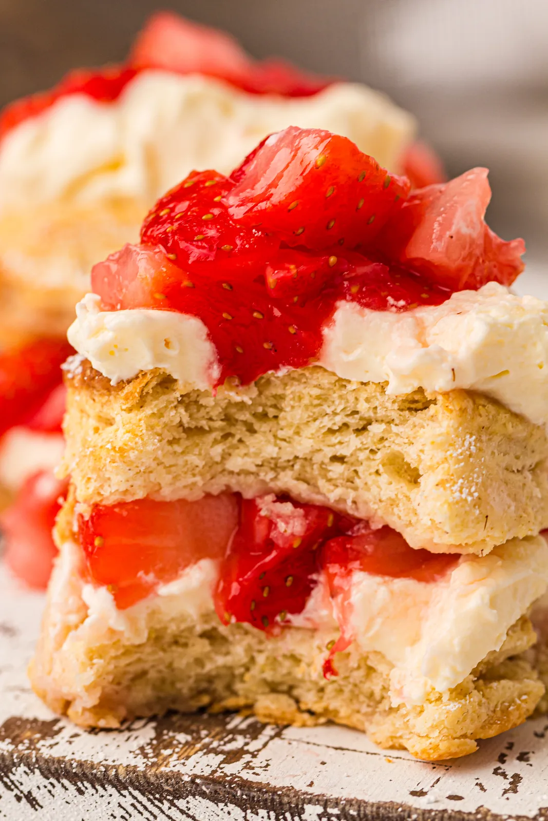 Golden biscuit split open and layered with fruit and softly whipped cream