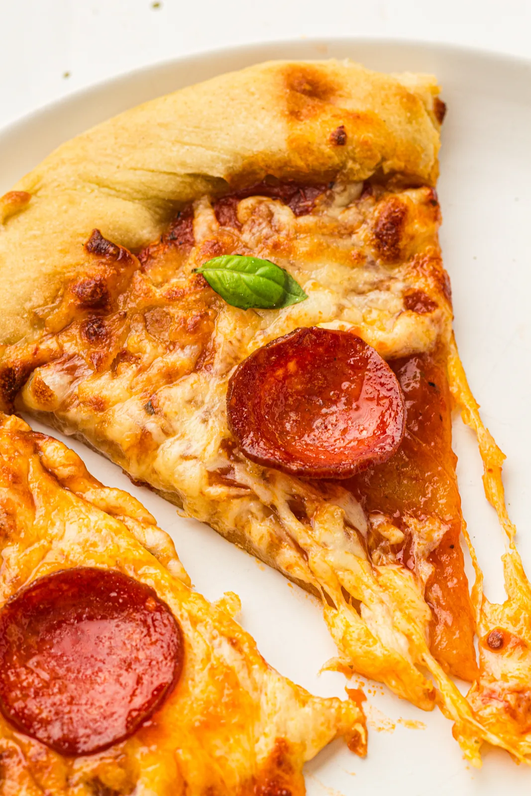 A slice lifted away with the cheese stretching behind it