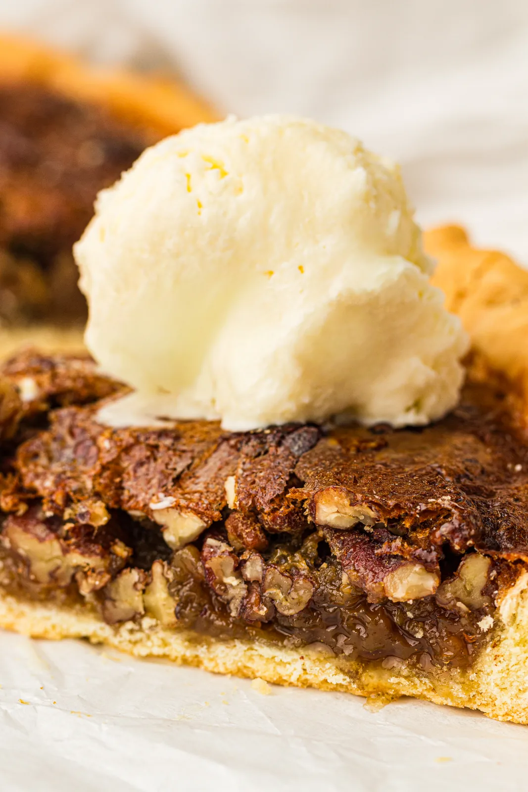 A slice served warm with a scoop of vanilla ice cream melting beside it
