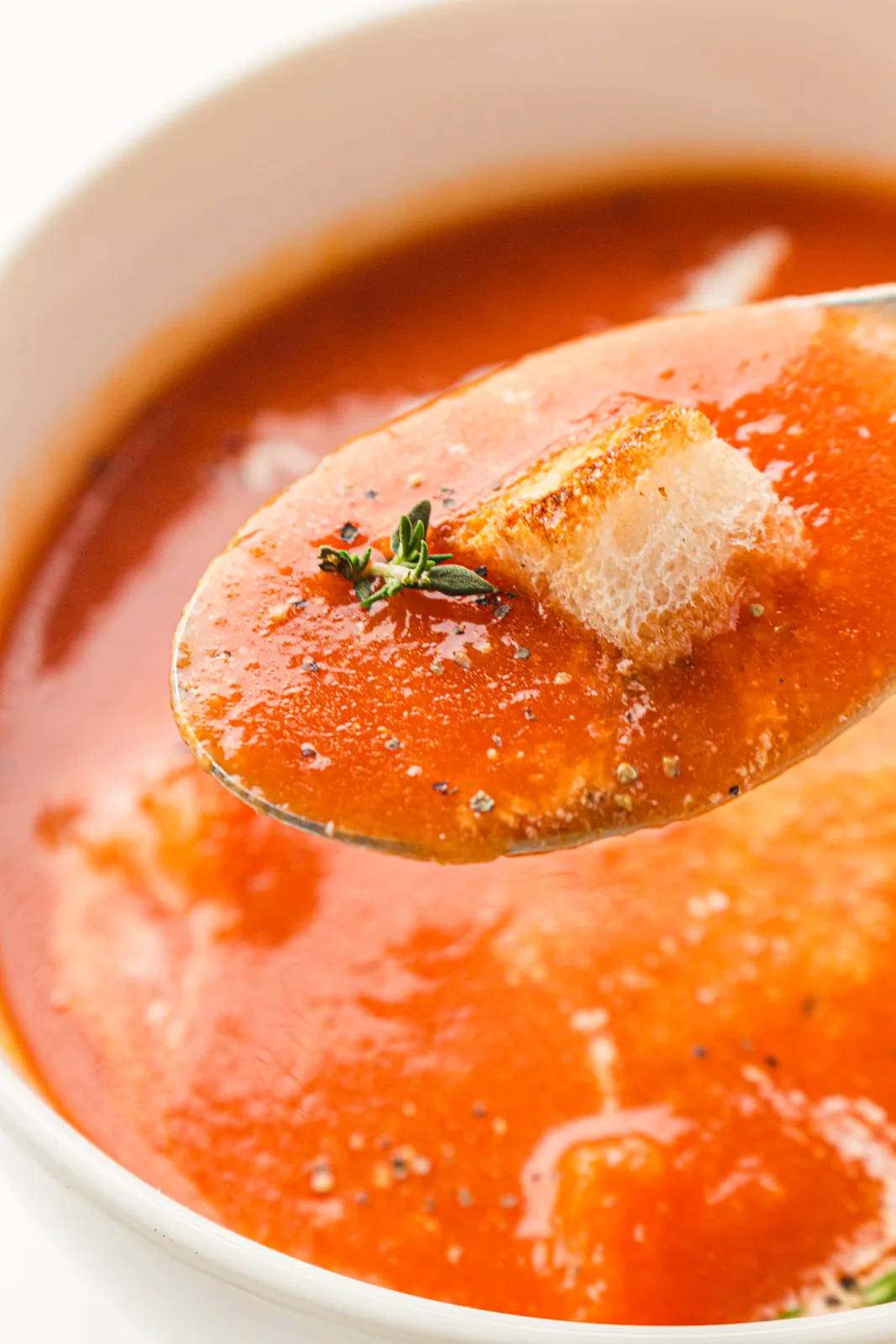 A spoonful lifted with a crisp golden crouton balanced on top