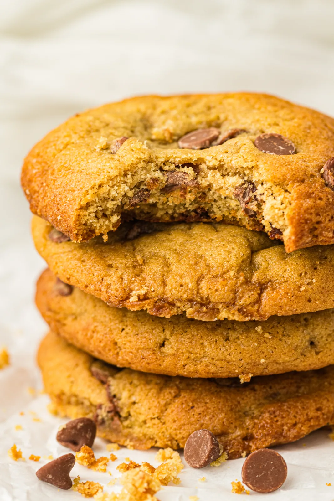 A stack of golden bakes with a bite taken out of the top one