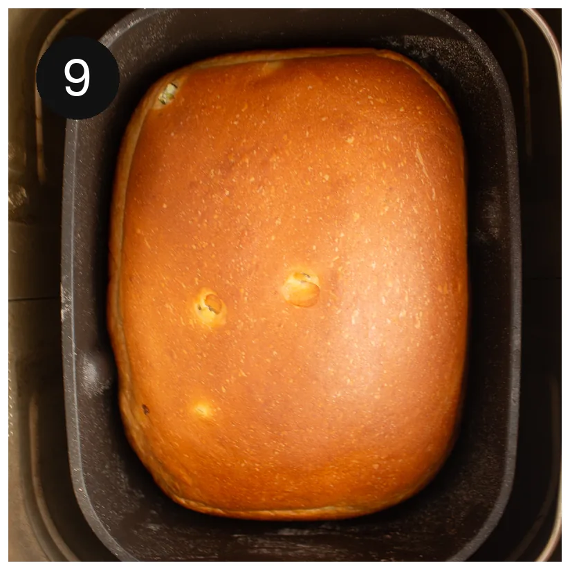 The finished golden loaf sitting in the machine pan