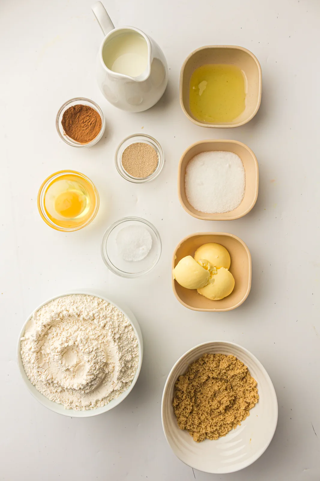 Ingredients for bread machine cinnamon bread: milk, egg, butter, sugar, flour, yeast, brown sugar and ground spice