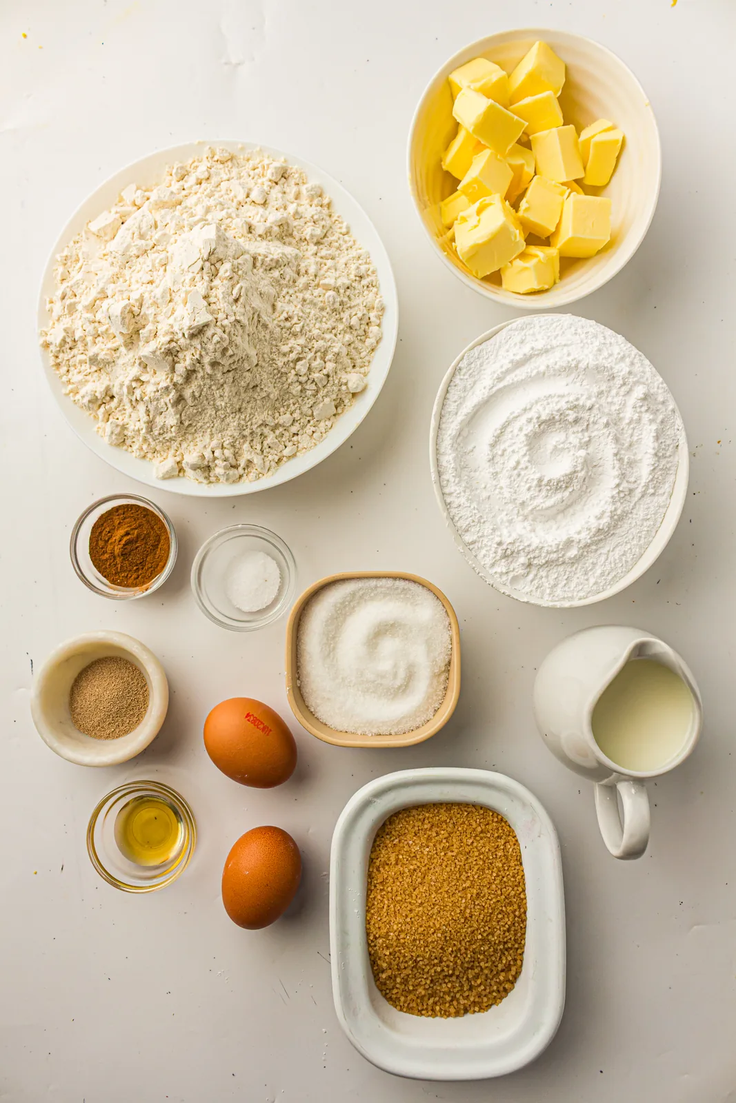 Ingredients for bread machine cinnamon rolls: flour, milk, eggs, butter, sugar and ground spice