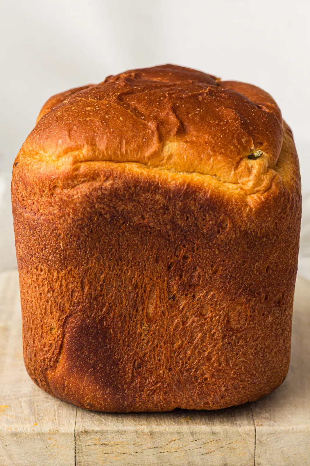 Bread machine jalapeno cheddar bread cooling on a wooden board