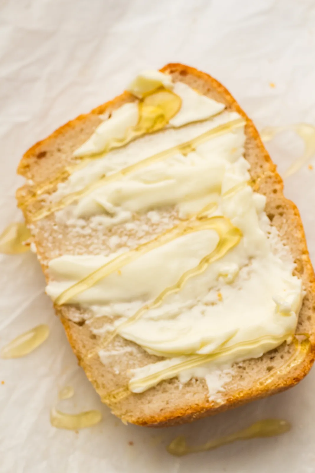 A thick buttered slice drizzled with honey on parchment