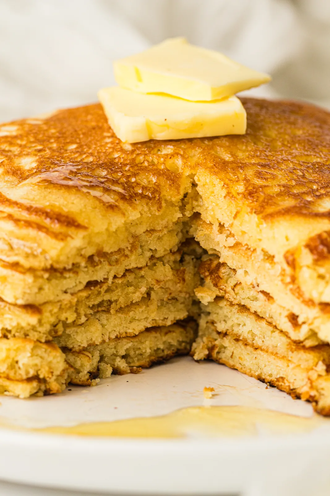 A buttered stack cut open to show the soft layers inside
