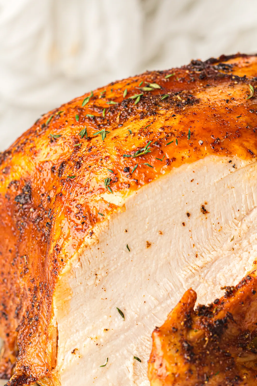 The carved breast showing juicy white meat under crisp skin