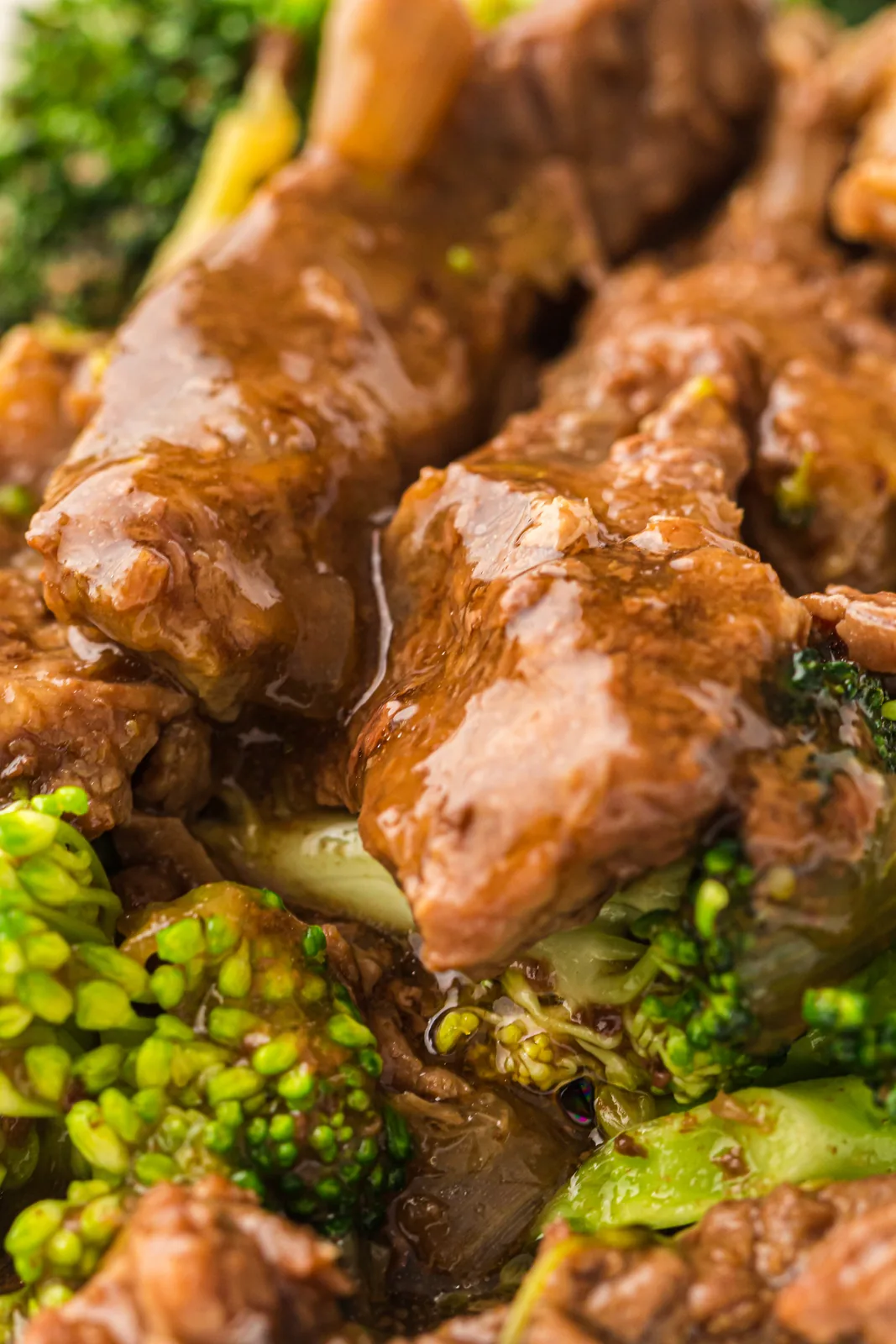 Close view of the thick glossy sauce clinging to tender strips