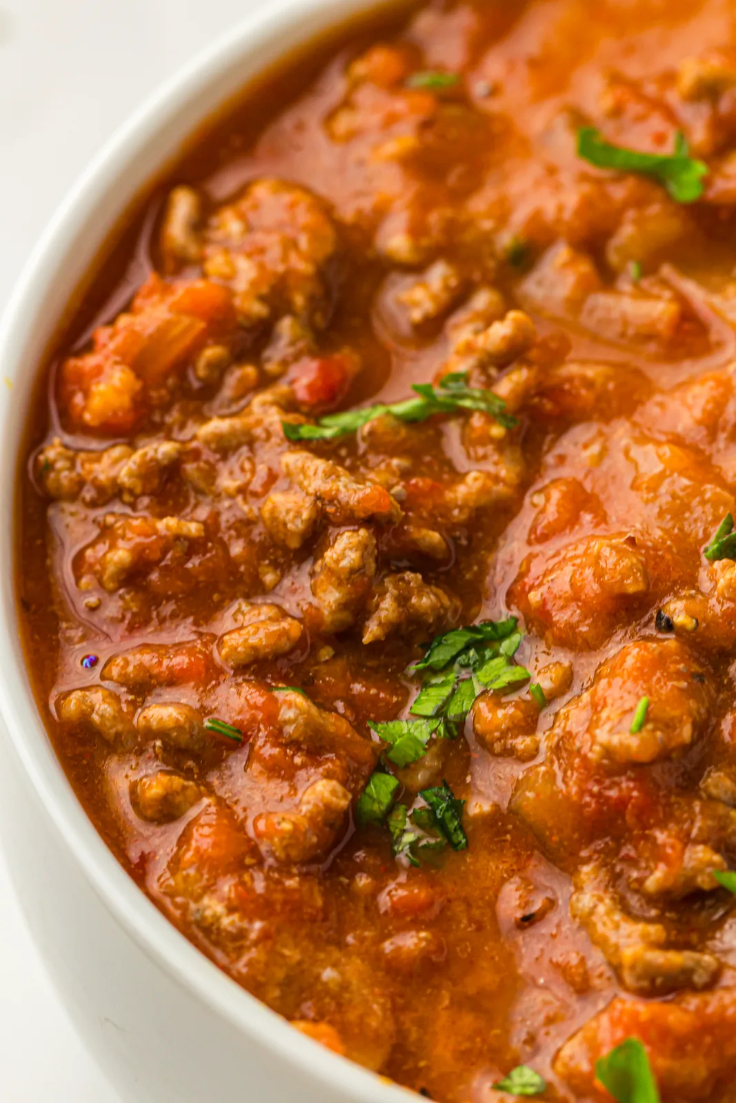 Close view of the thick meaty sauce scattered with fresh coriander