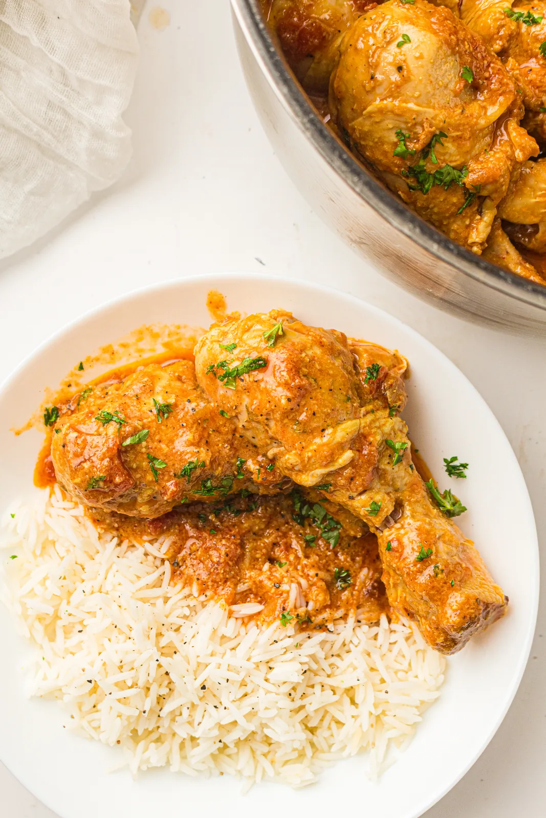 Coconut chicken curry served over steamed rice with fresh herbs