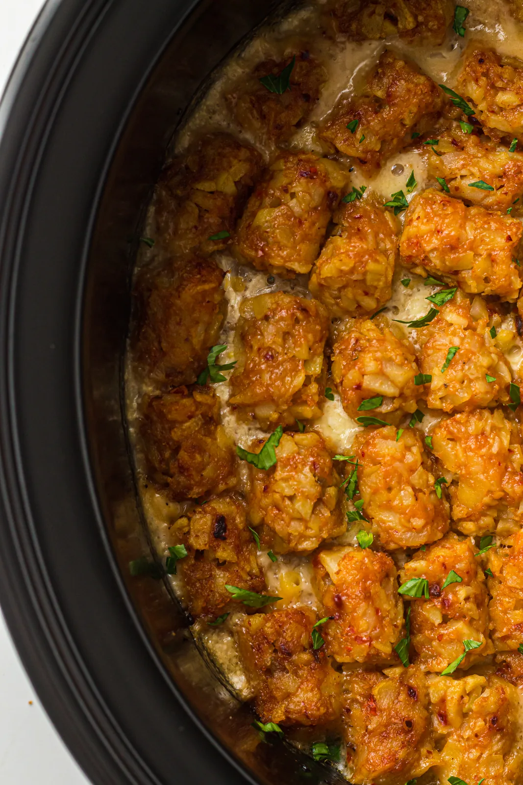 Slow cooker cowboy casserole with a golden lid of crisp potato nuggets