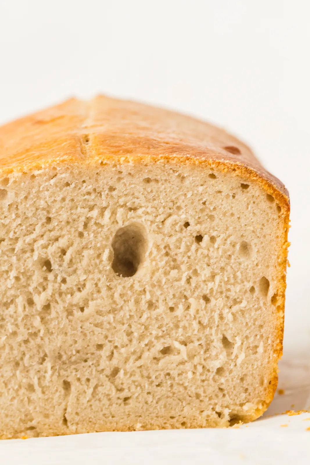 The cut loaf showing an even, soft crumb inside a thin crust