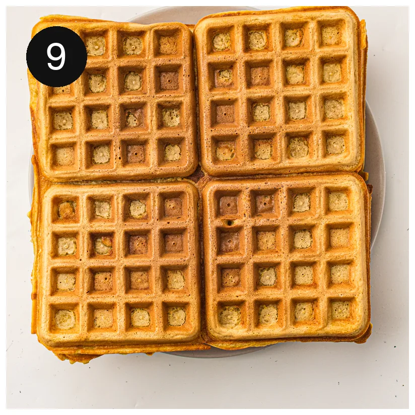 Four golden squares stacked on a plate, fresh from the iron
