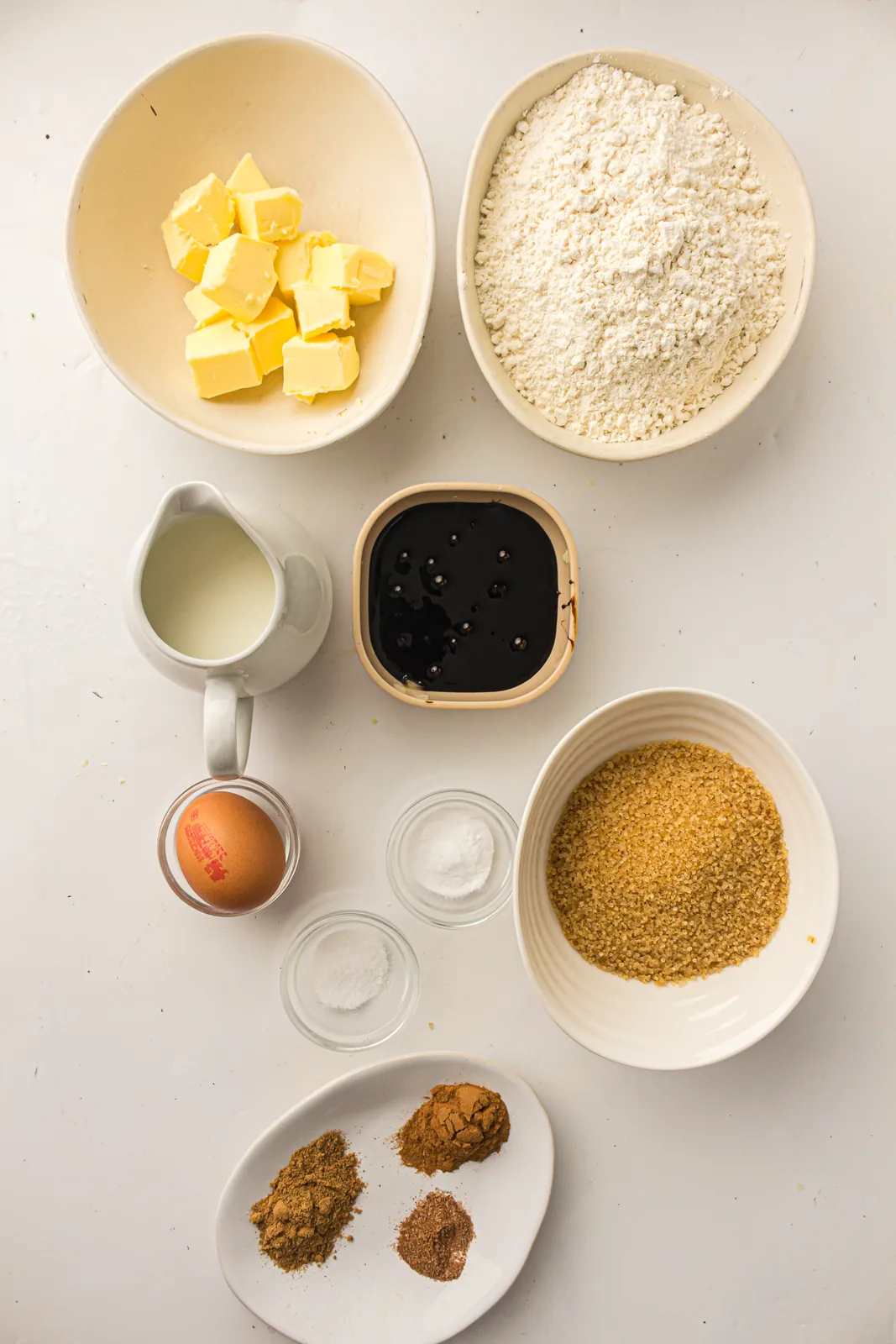 Ingredients for gingerbread loaf: butter, flour, brown sugar, molasses, milk, egg and warm spices