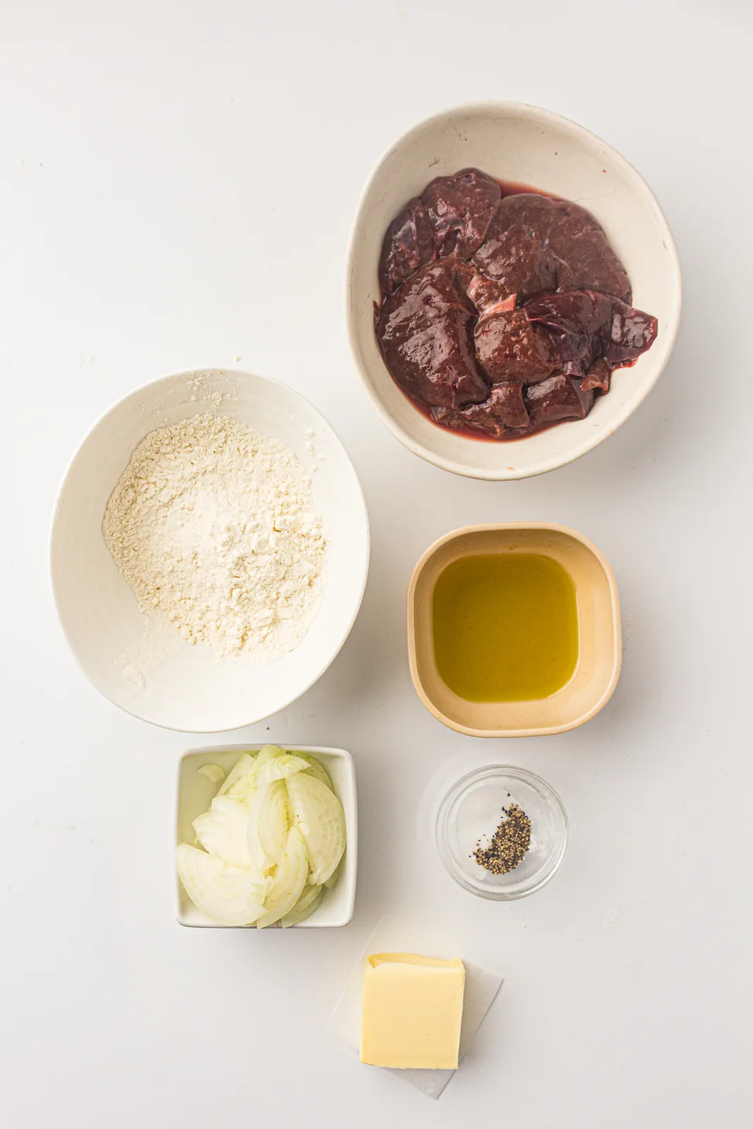 Ingredients for liver and onions: sliced beef liver, flour, butter, oil and onions