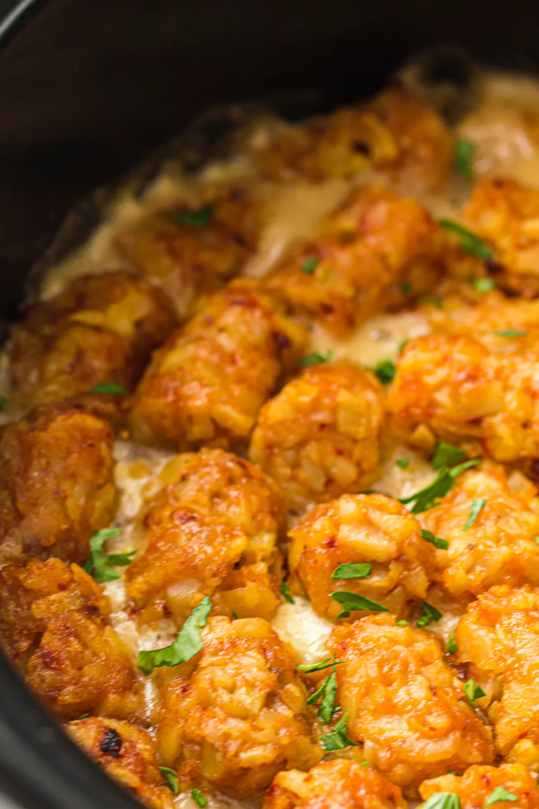 Melted cheese bubbling underneath the golden crisp topping