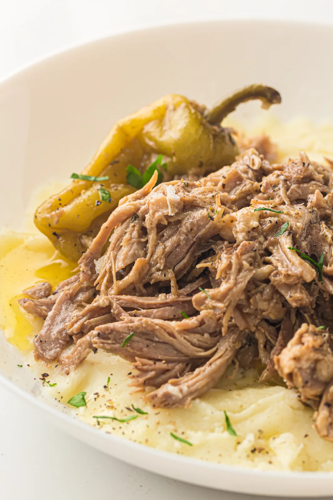 Mississippi pork roast shredded over mashed potato with pepperoncini