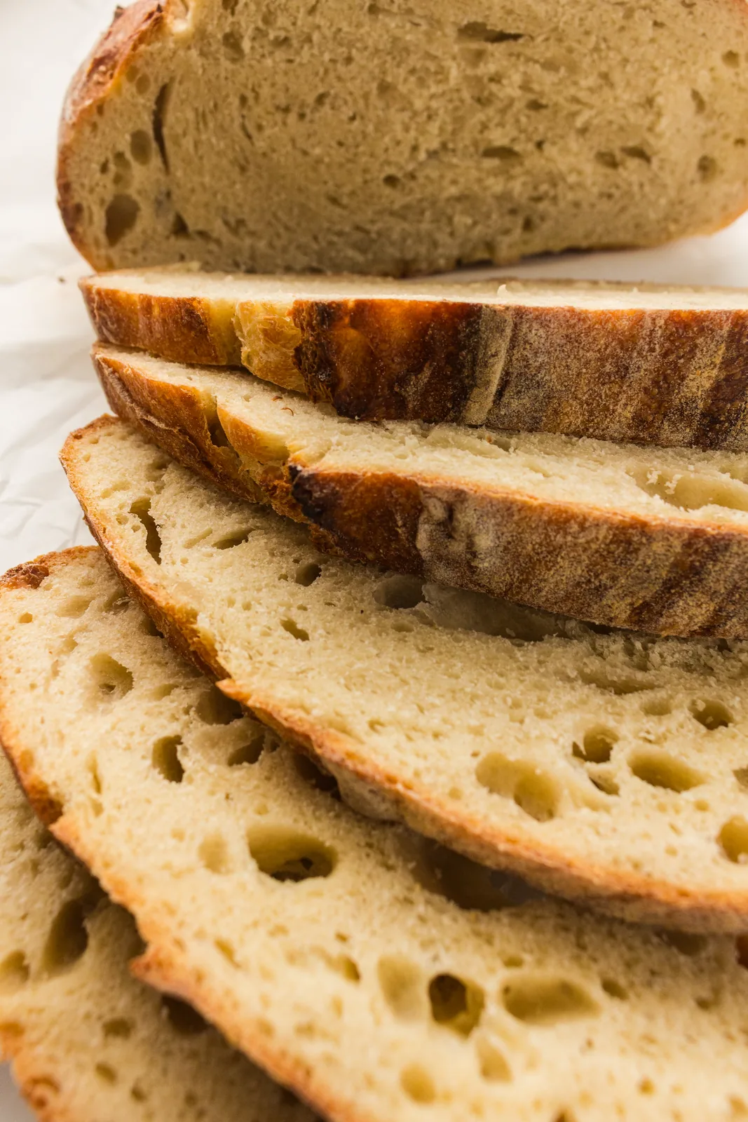 Slices fanned out showing an open, holey crumb