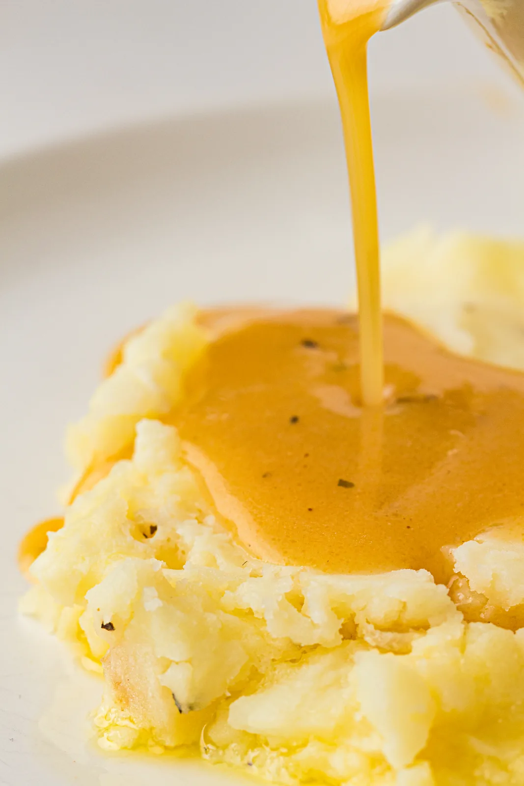 A steady stream poured over a mound of buttery mashed potato