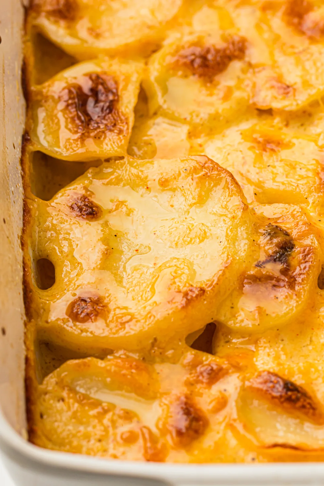 Scalloped potatoes without cheese baked golden in a white dish