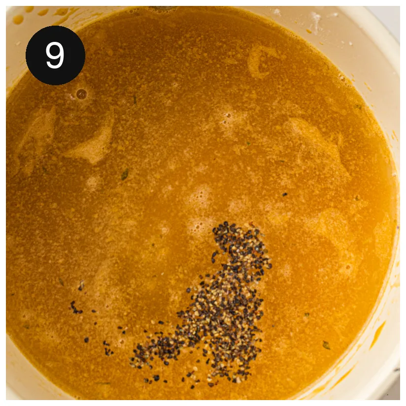 The finished sauce seasoned with cracked pepper and simmered until glossy