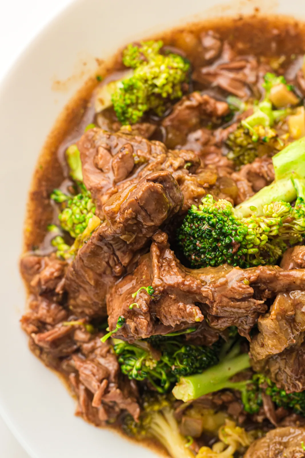 Bowl of slow cooker beef and broccoli with glossy sauce and bright green florets