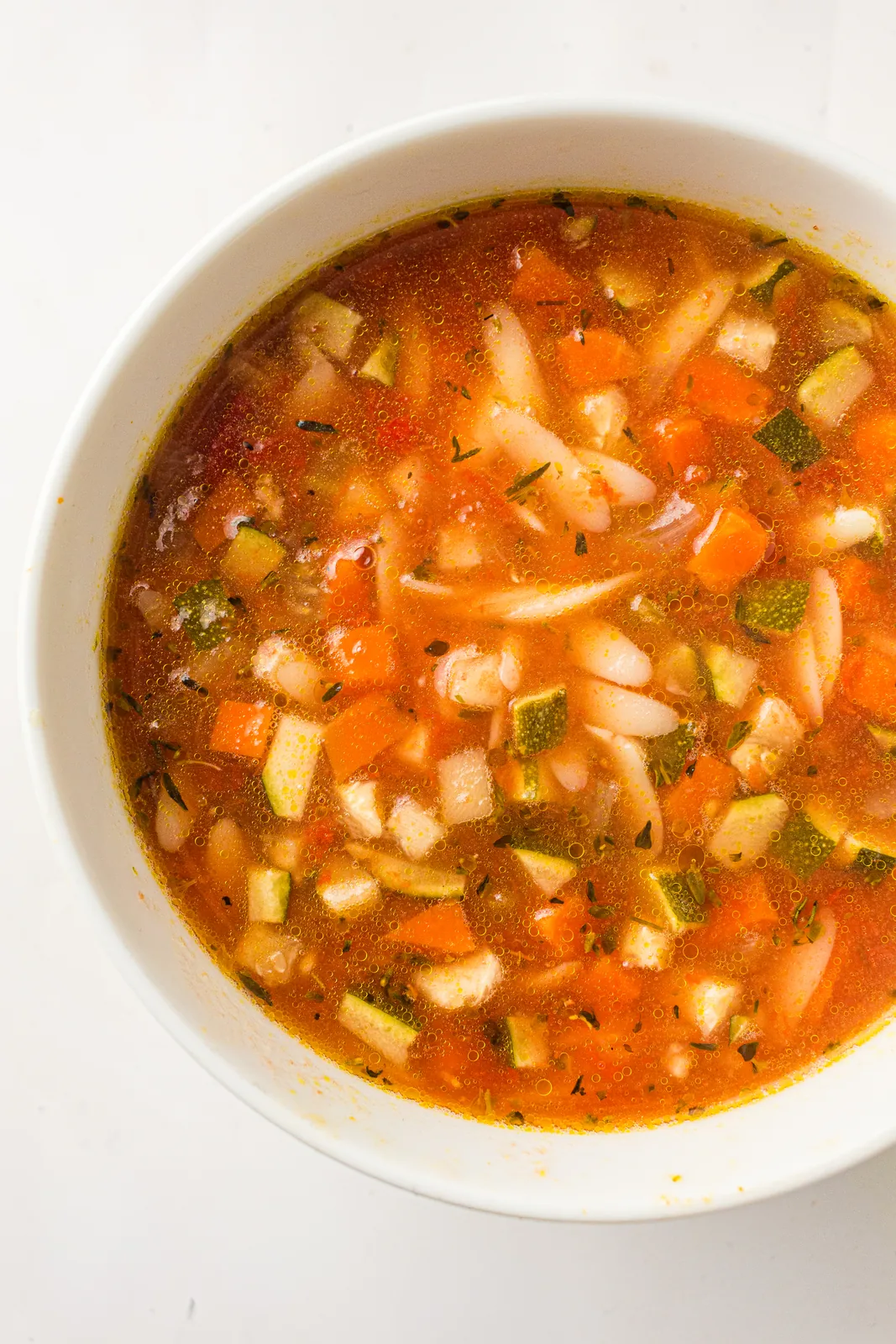 A bowl of slow cooker minestrone soup with beans, carrot and small pasta