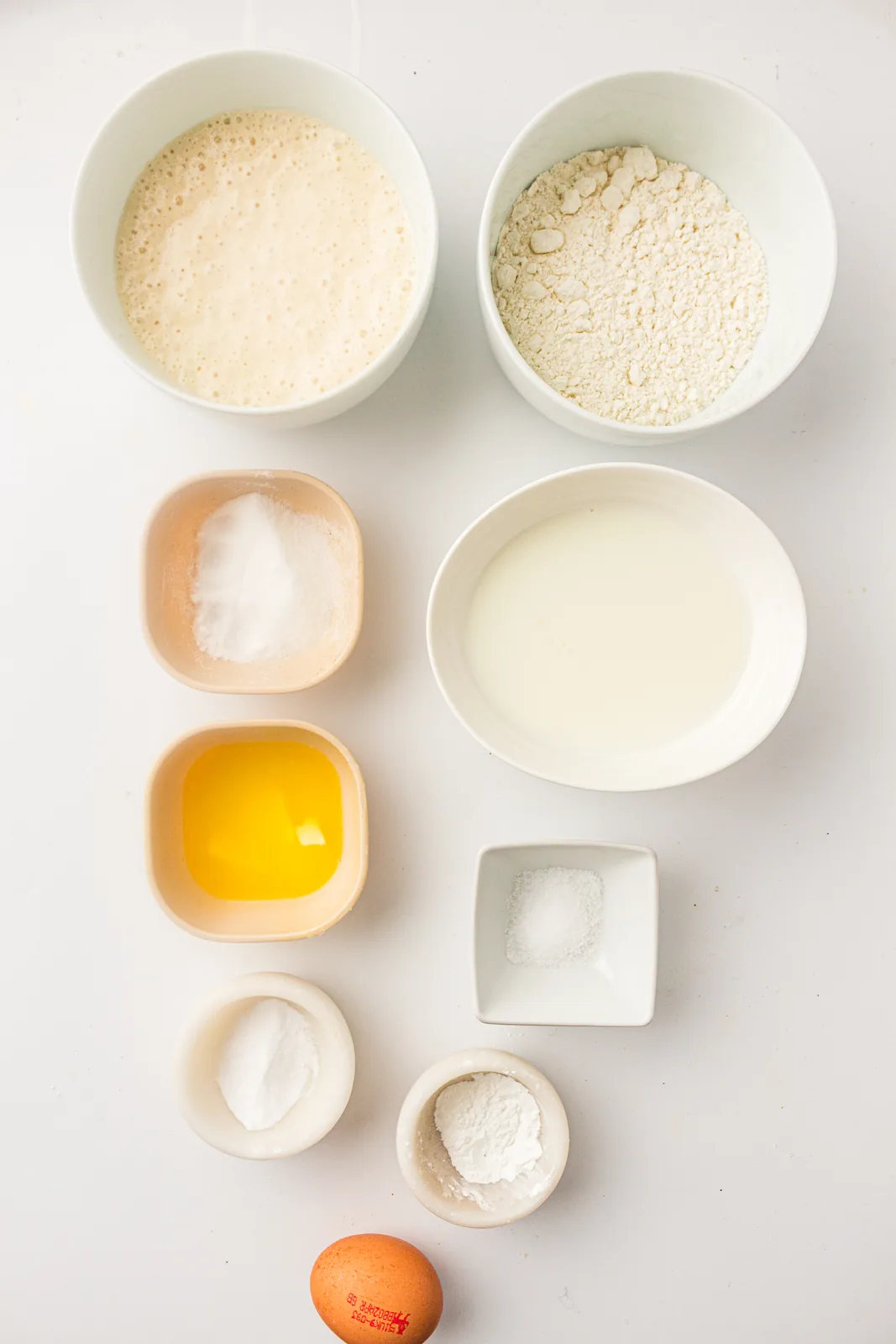Ingredients for sourdough discard pancakes: flour, sugar, raising agents, salt, egg, milk and melted butter