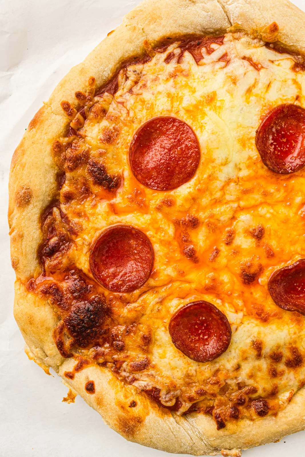 A whole pizza made with sourdough pizza dough seen from above