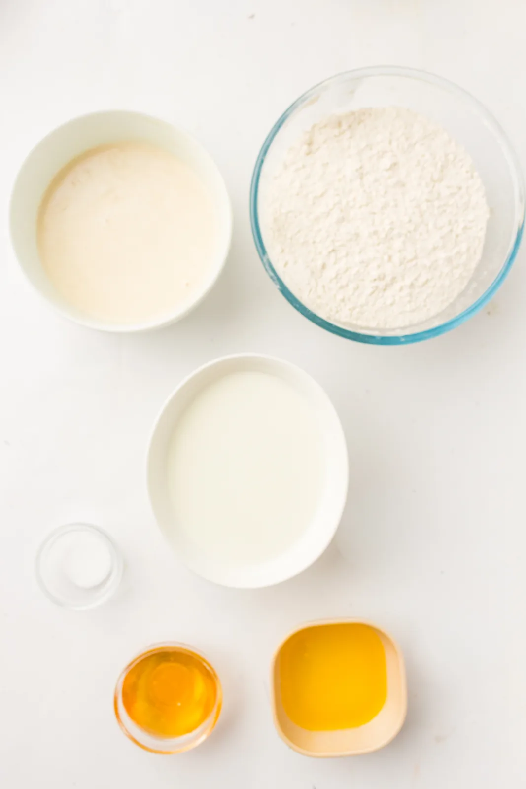 Ingredients for sourdough sandwich bread: active starter, bread flour, water, melted butter, honey and salt