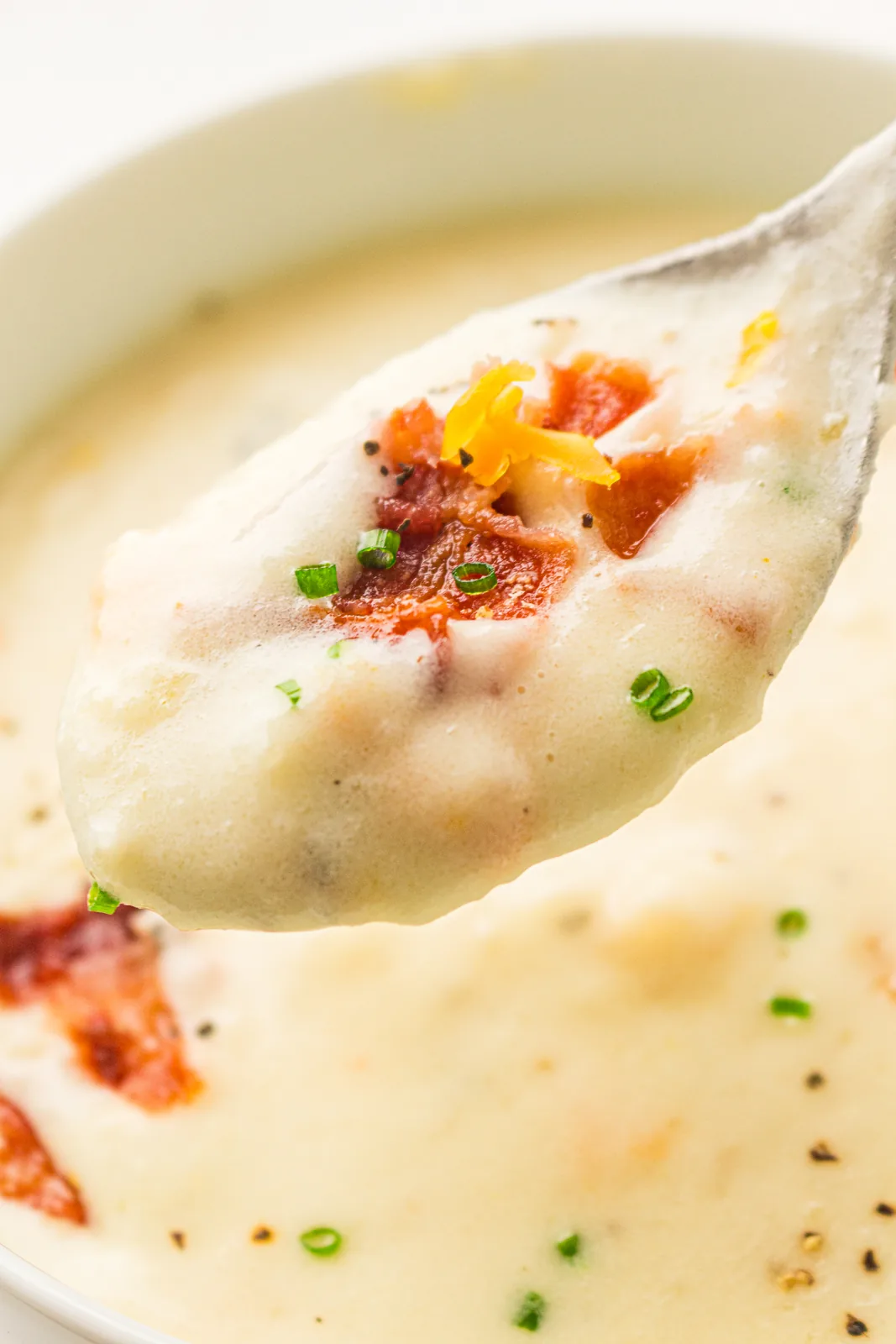 A spoonful of the chunky creamy mixture lifted above the bowl