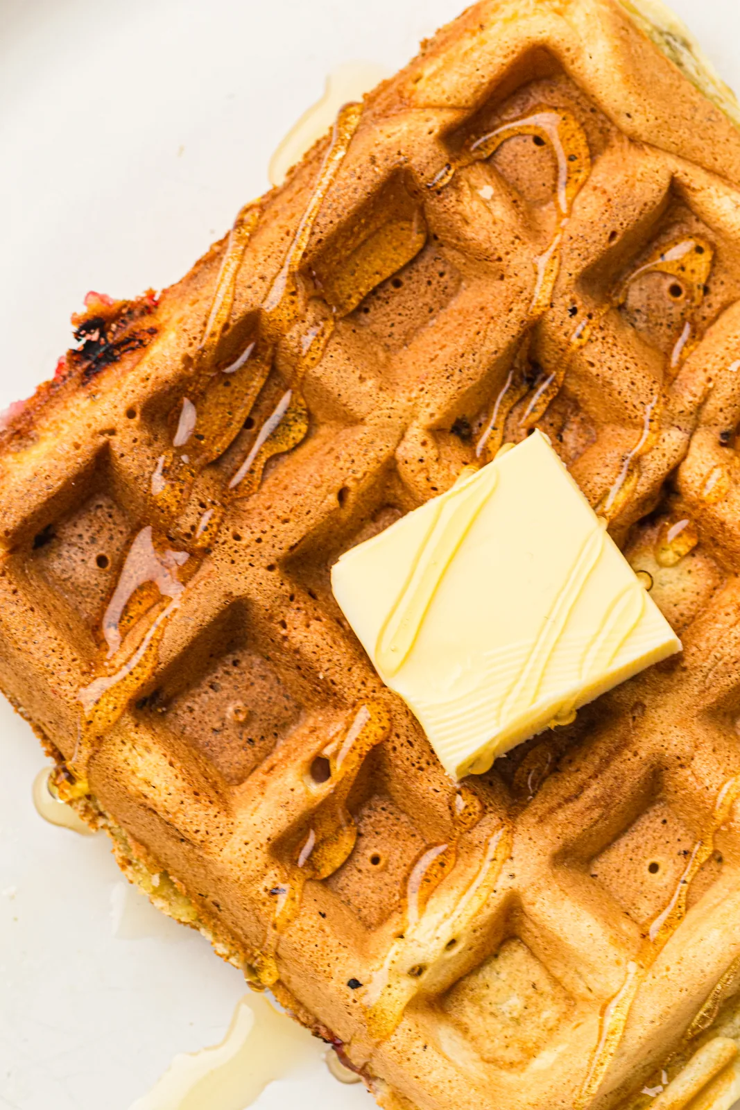 Syrup running over the ridges of a crisp golden square