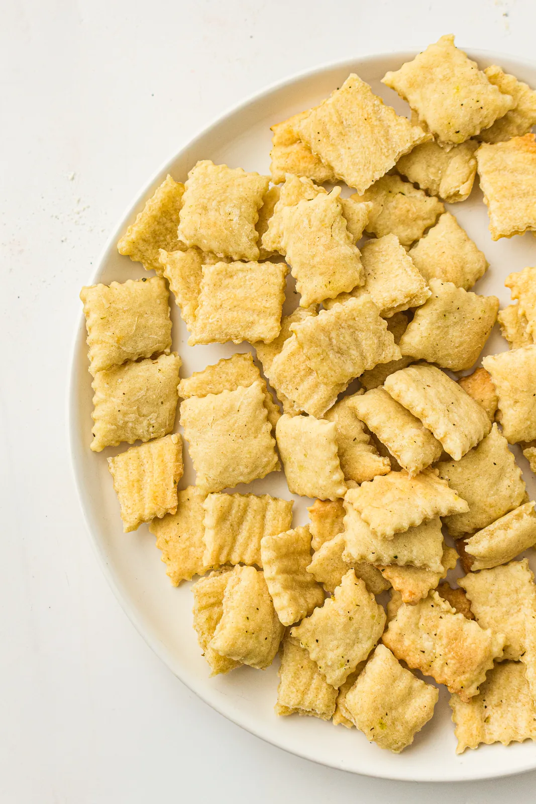 Thin golden squares piled on a white plate