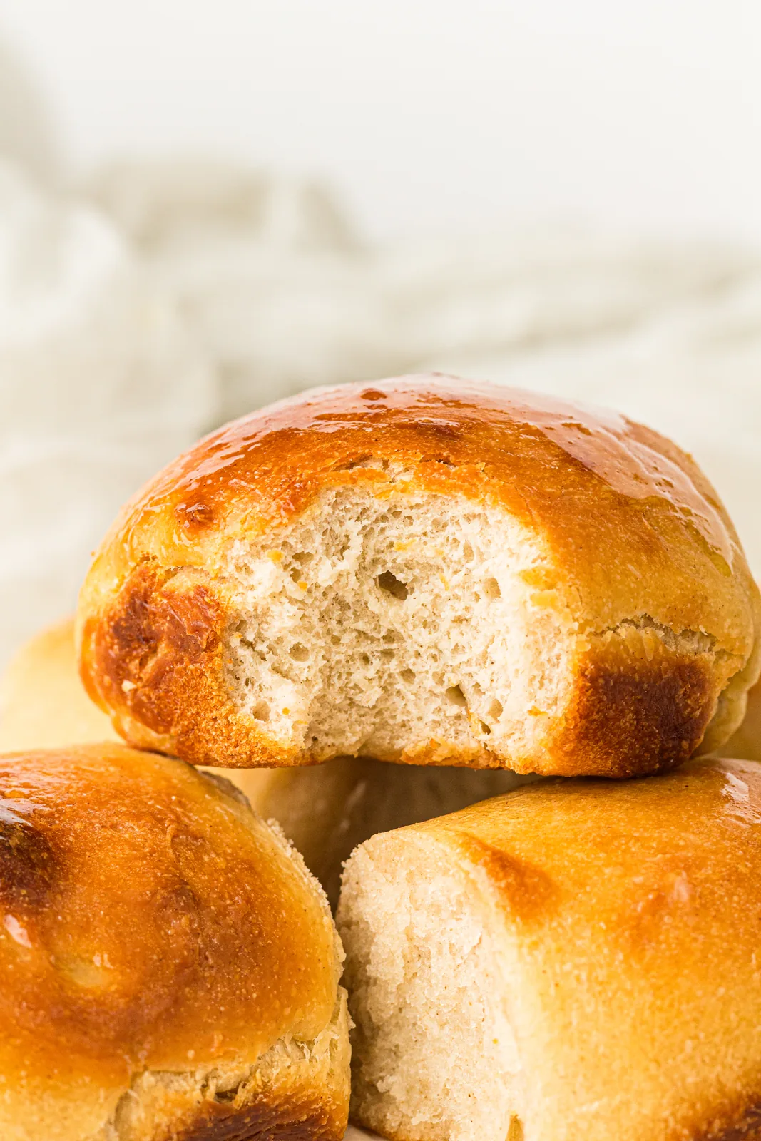 A torn open bun showing the soft open crumb inside
