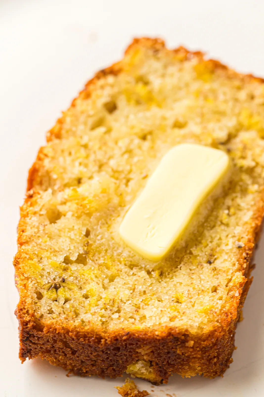 A warm slice with a pat of butter melting on top