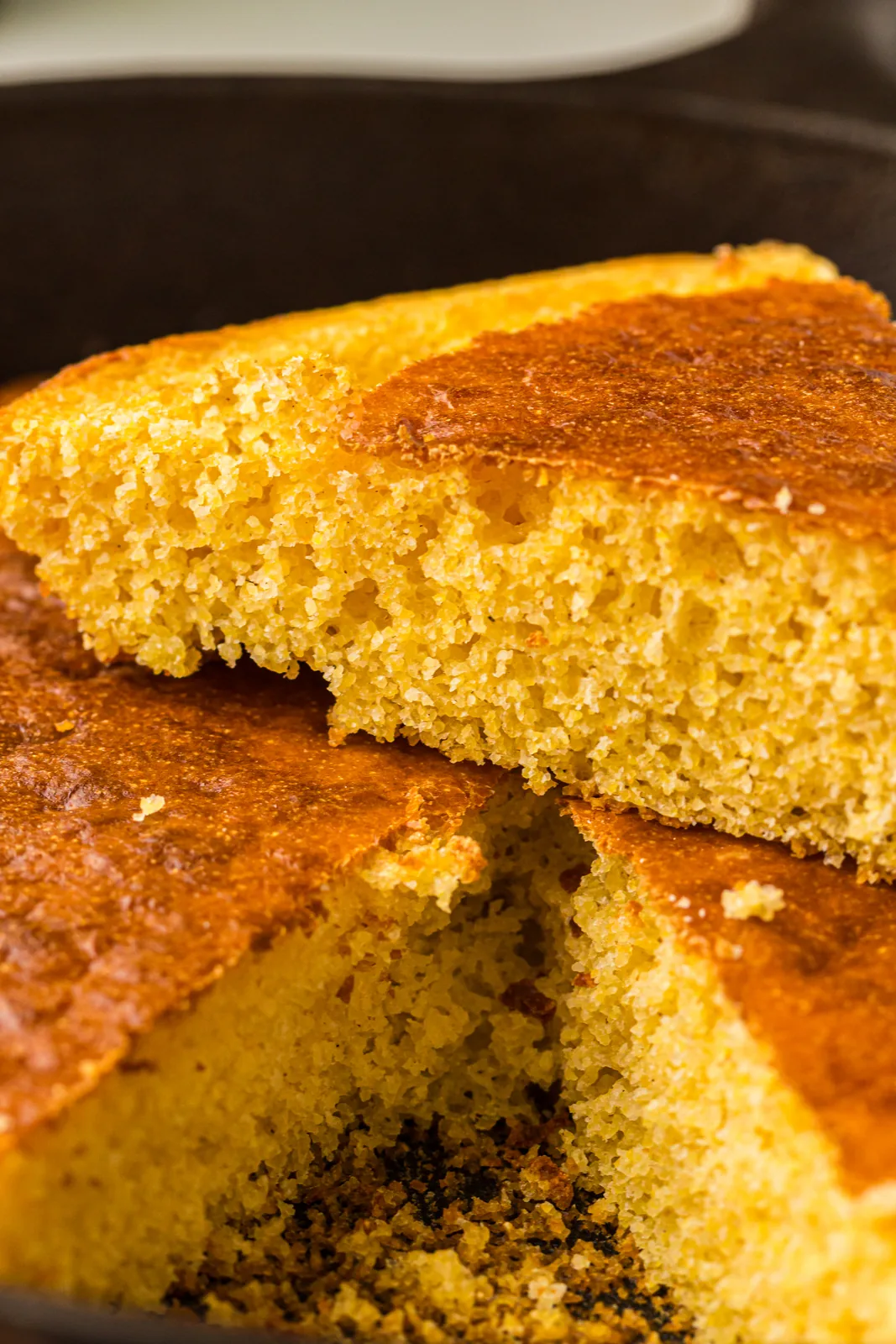 A wedge being lifted out of the hot pan with the crumb showing