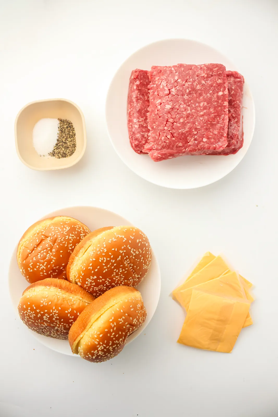 Ingredients for Blackstone smash burgers: ground beef, salt and pepper, sesame seed buns and American cheese slices