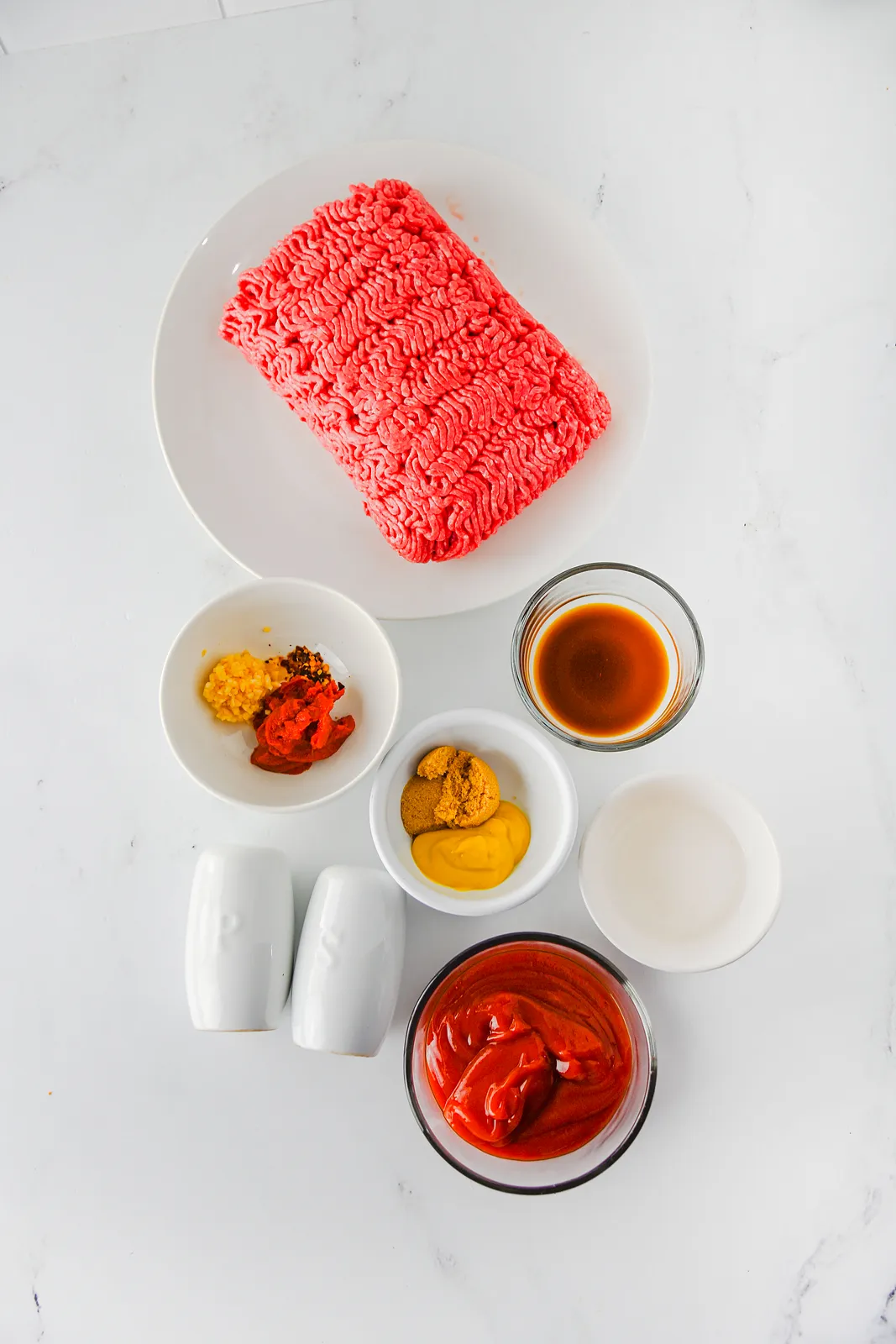 Ingredients for crock pot sloppy joes: ground beef, ketchup, tomato paste, mustard, brown sugar and seasonings