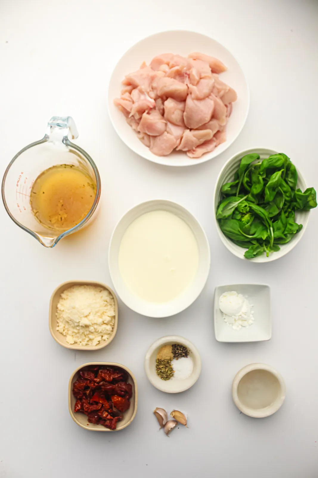 Ingredients for crockpot marry me chicken: diced breast, broth, cream, Parmesan, sun-dried tomatoes, basil, garlic, spices and cornstarch