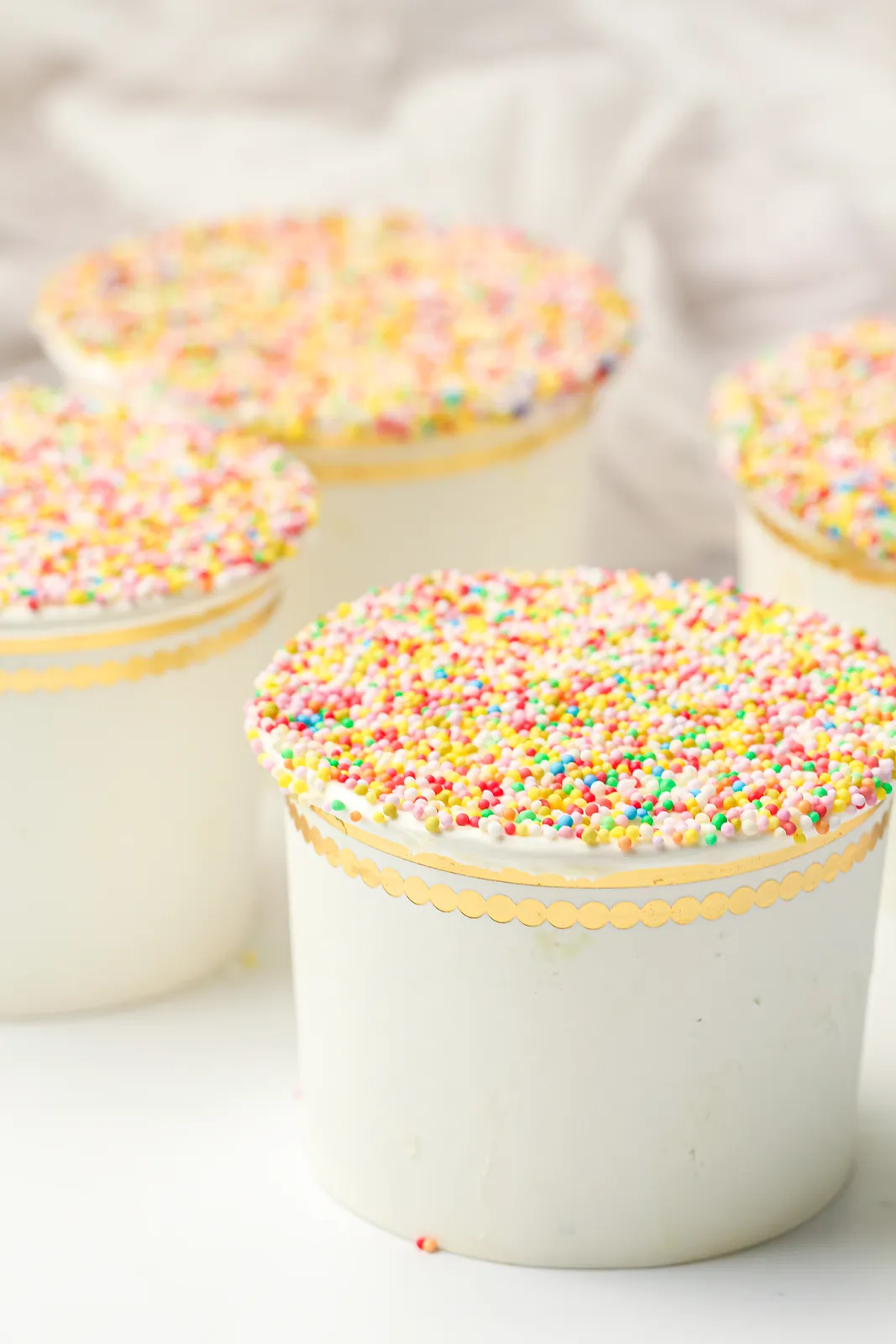 Dot cake cups topped with rainbow hundreds and thousands