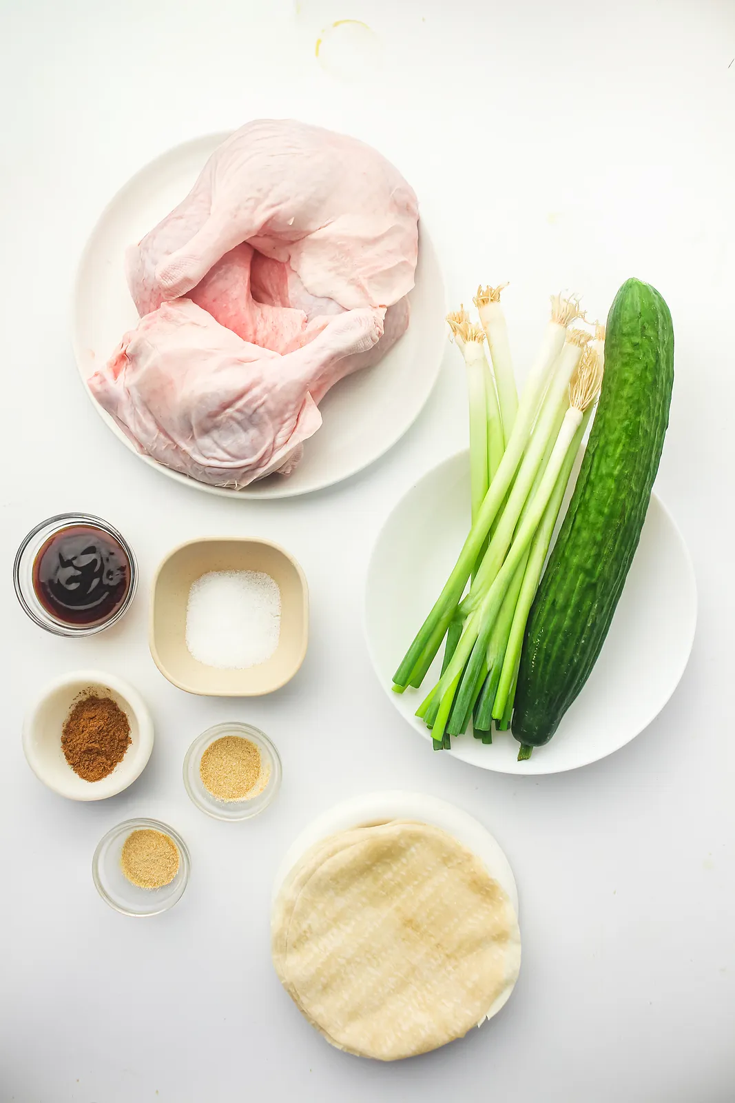 Ingredients for duck pancakes: duck legs, five spice, hoisin, Chinese pancakes, cucumber and spring onions