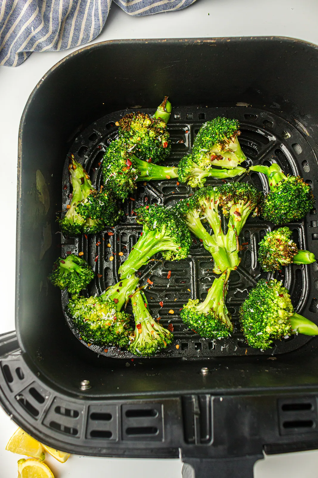 Golden florets in the fryer basket scattered with red chilli flakes