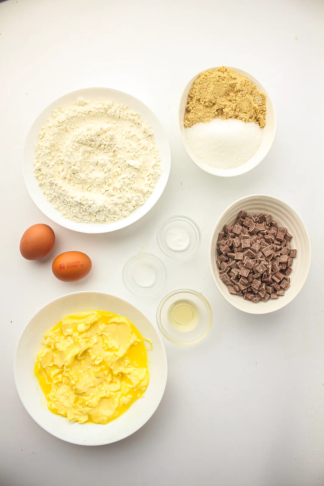 Ingredients for freezer cookie dough: softened butter, brown and white sugar, flour, eggs, vanilla, baking soda, salt and chocolate chunks