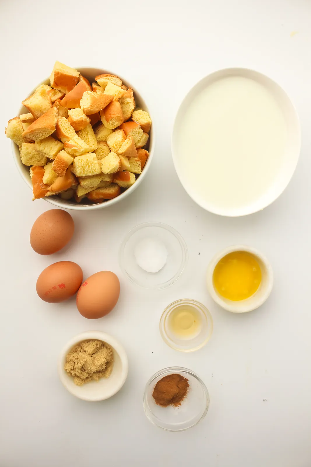 Ingredients for freezer French toast: cubed brioche, eggs, milk, brown sugar, cinnamon, vanilla, salt and melted butter
