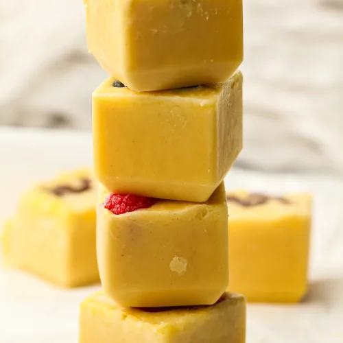 Freezer pancakes stacked as golden batter cubes topped with blueberries and raspberries