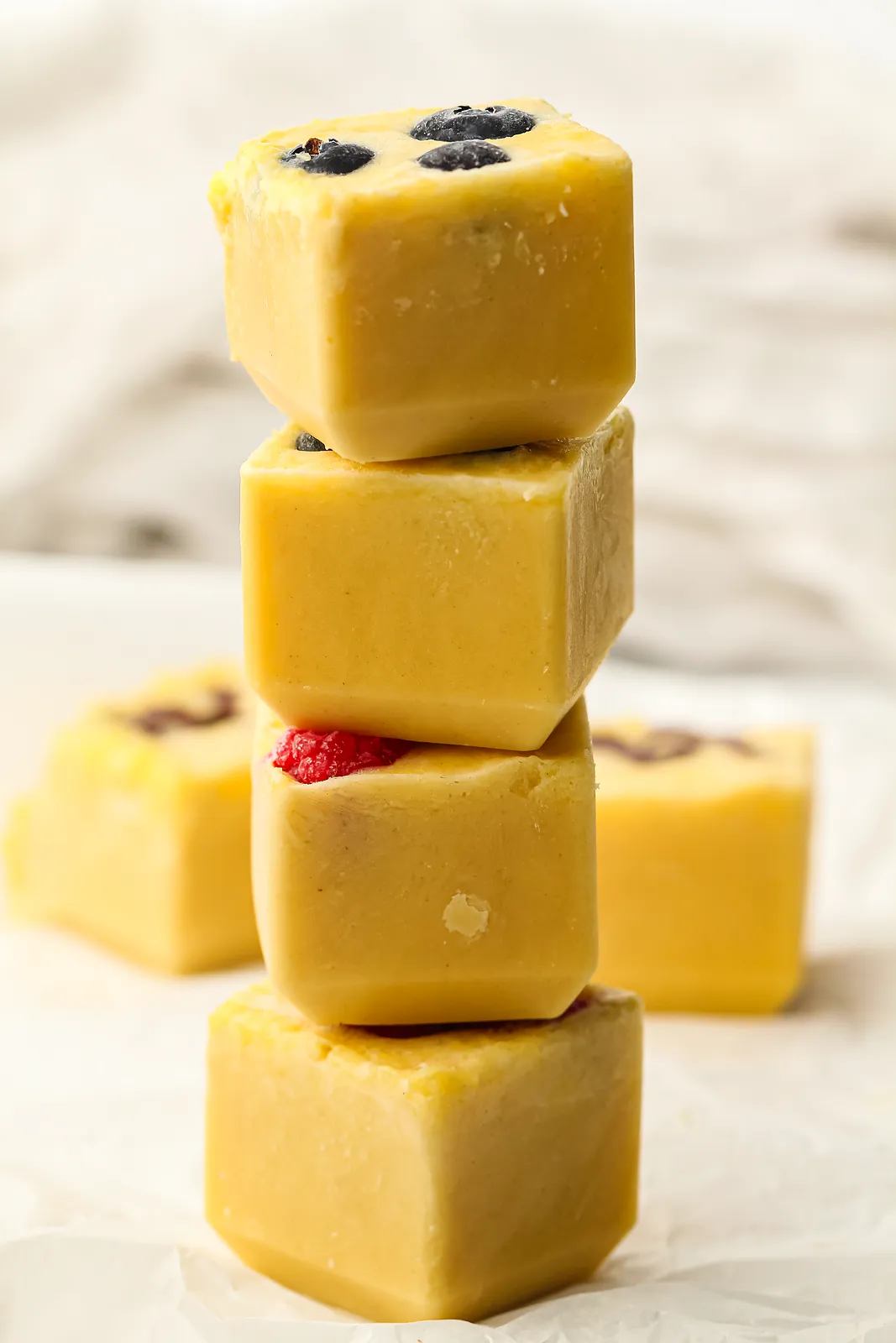Freezer pancakes stacked as golden batter cubes topped with blueberries and raspberries
