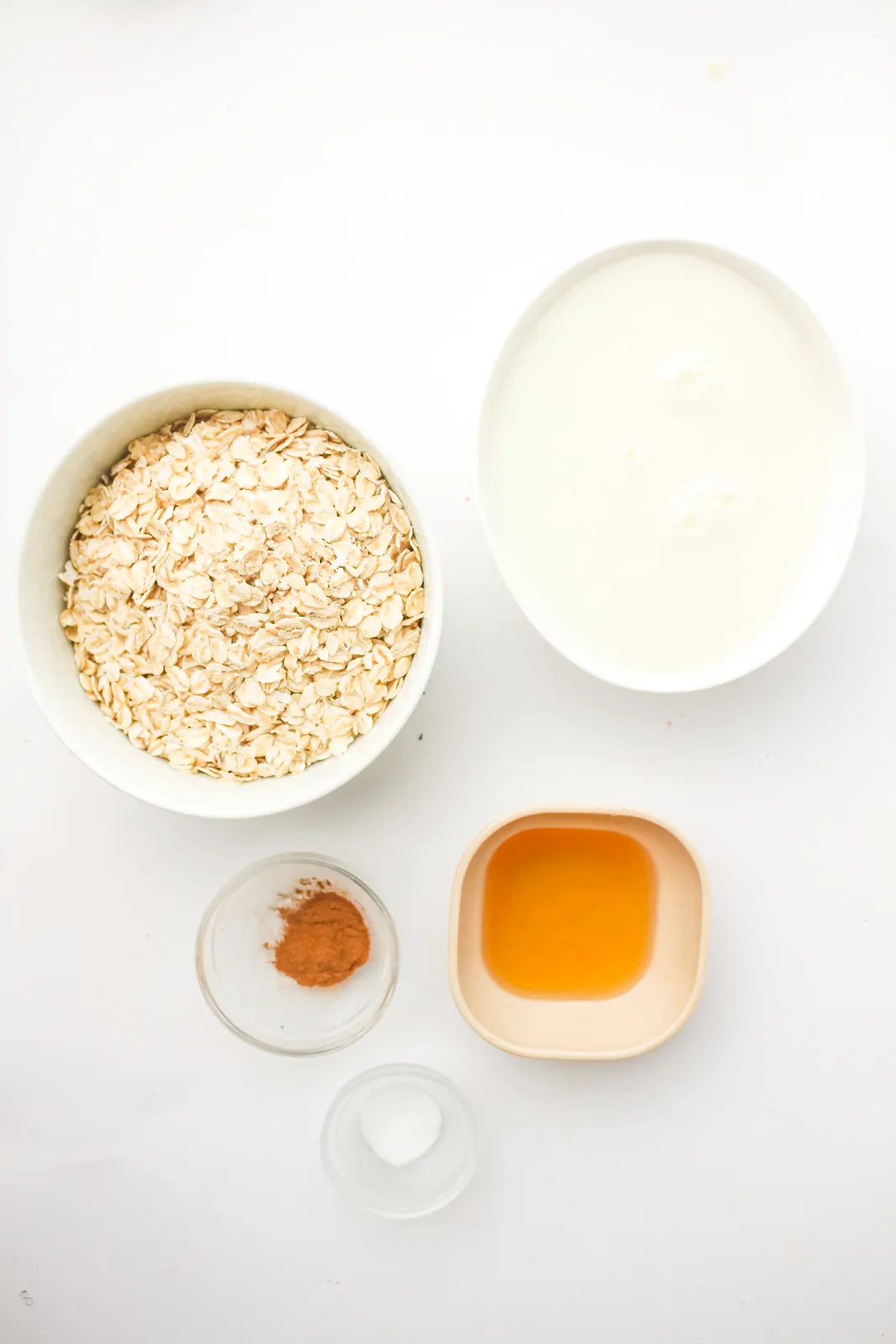 Ingredients for frozen oatmeal: rolled oats, milk, maple syrup, ground cinnamon and salt